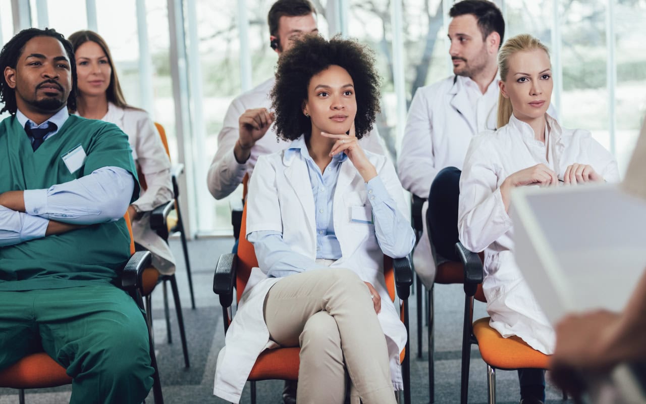 Doctor colleagues listening at an event