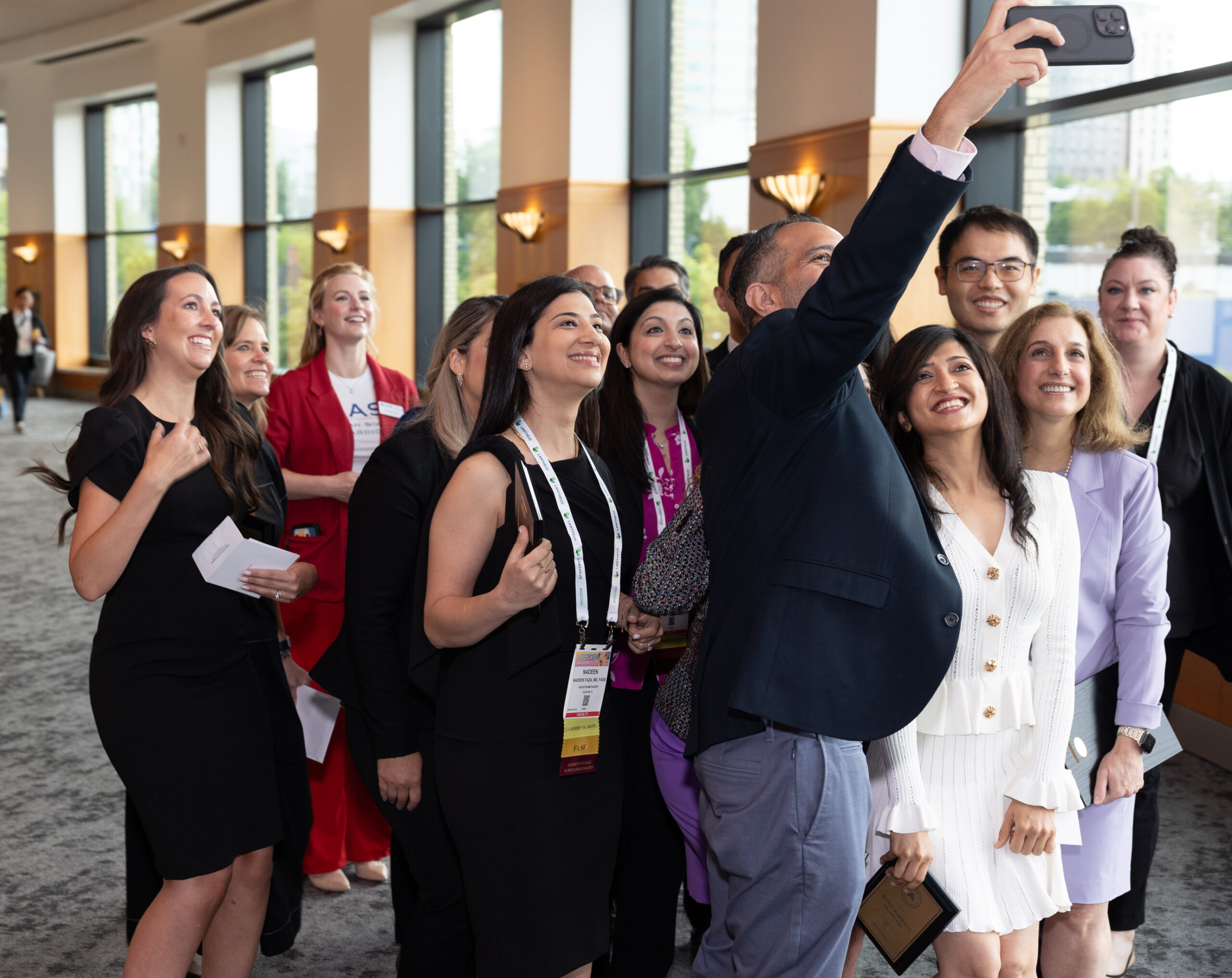 Man taking a selfie with colleagues